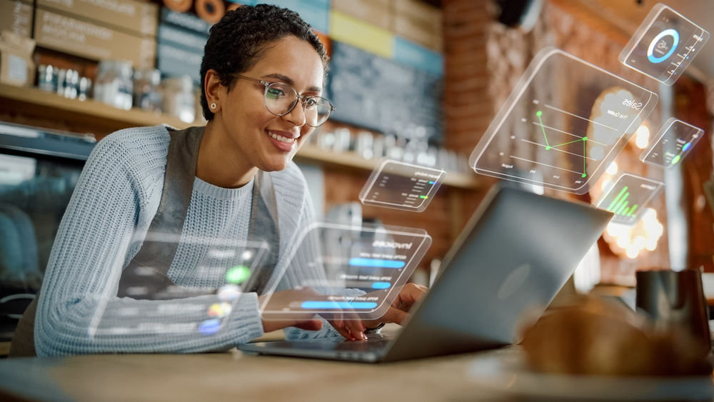 A female business owner looks at a laptop